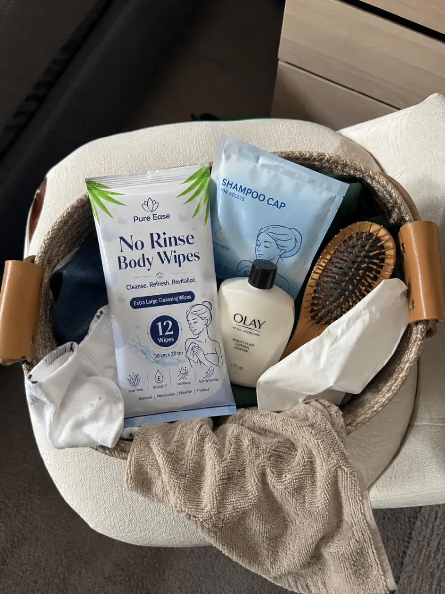 PureEase body wipes and shampoo cap in a care basket with toiletries.