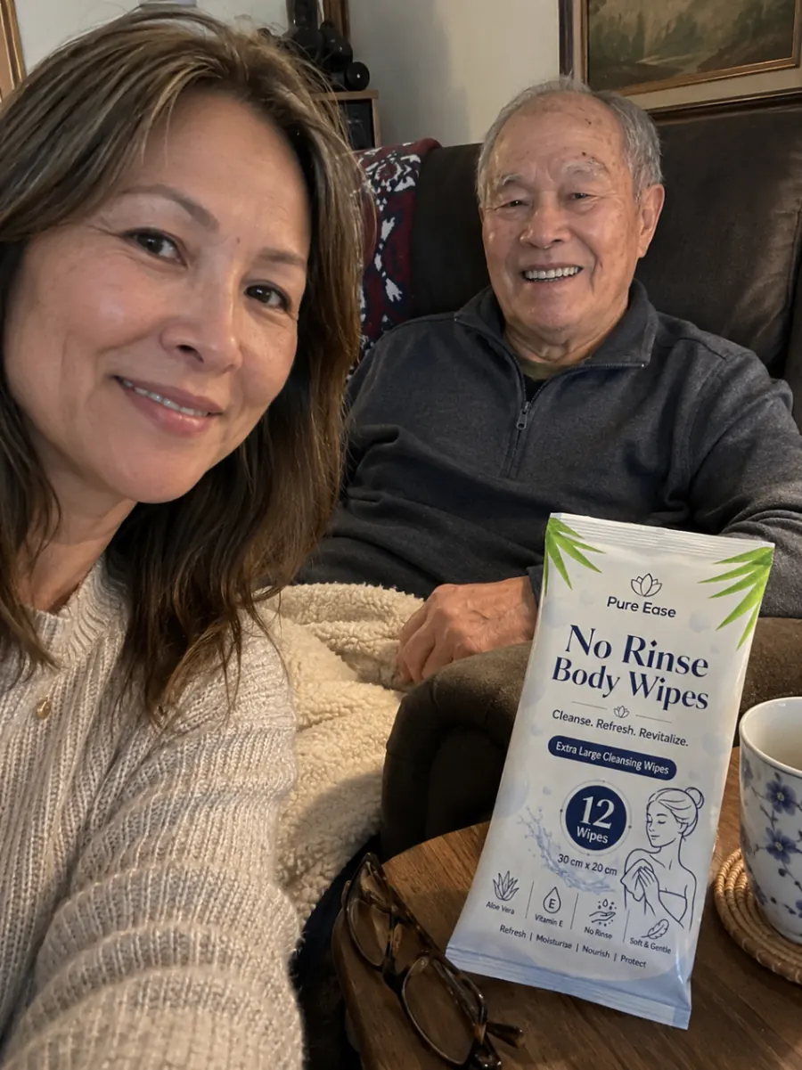 Customer selfie with an older man and PureEase body wipes on a side table.